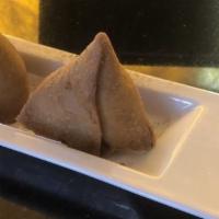 Veg Samosa · Vegan. Flour based pastry stuffed with mildly spiced potatoes, peas and fried to golden brown.