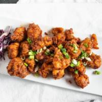Chicken 65 ** · Tender chicken chunks tossed in spiced yogurt sauce with curry leaves