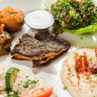 Meza Sampler · Hummus, Baba ganoush, kibbeh, kafta, falafel, grape leaves, and tabbouleh.
