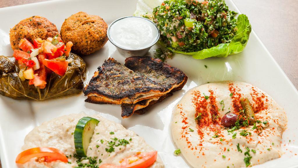 Meza Sampler · Hummus, Baba ganoush, kibbeh, kafta, falafel, grape leaves, and tabbouleh.