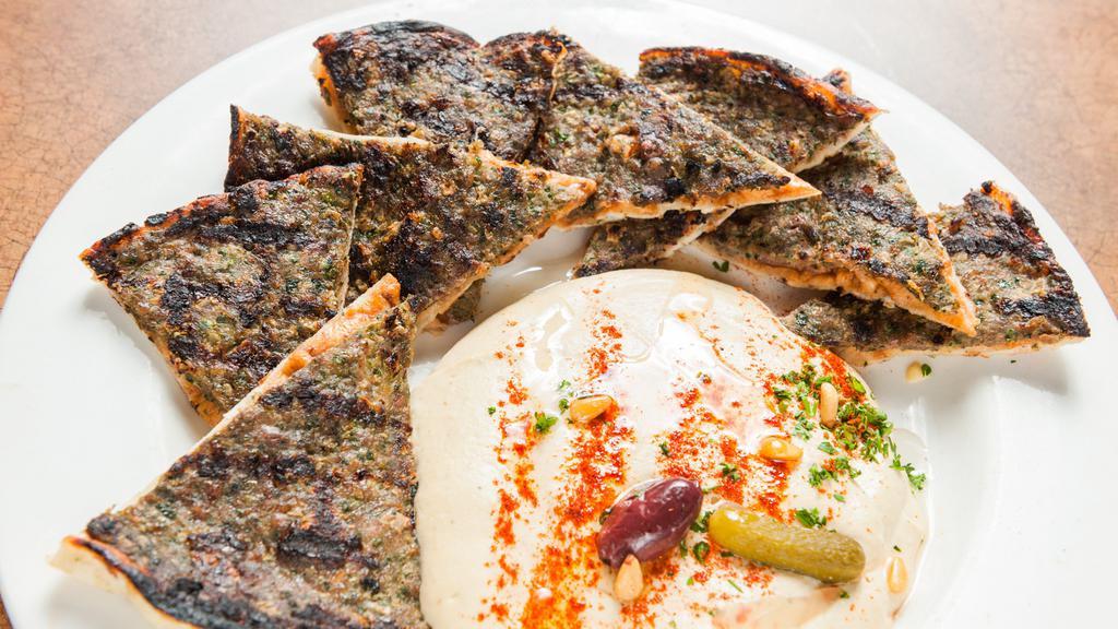 Kafta · Fresh ground beef minced with onions, spices, and parsley, on pita. Grilled and served with hummus.
