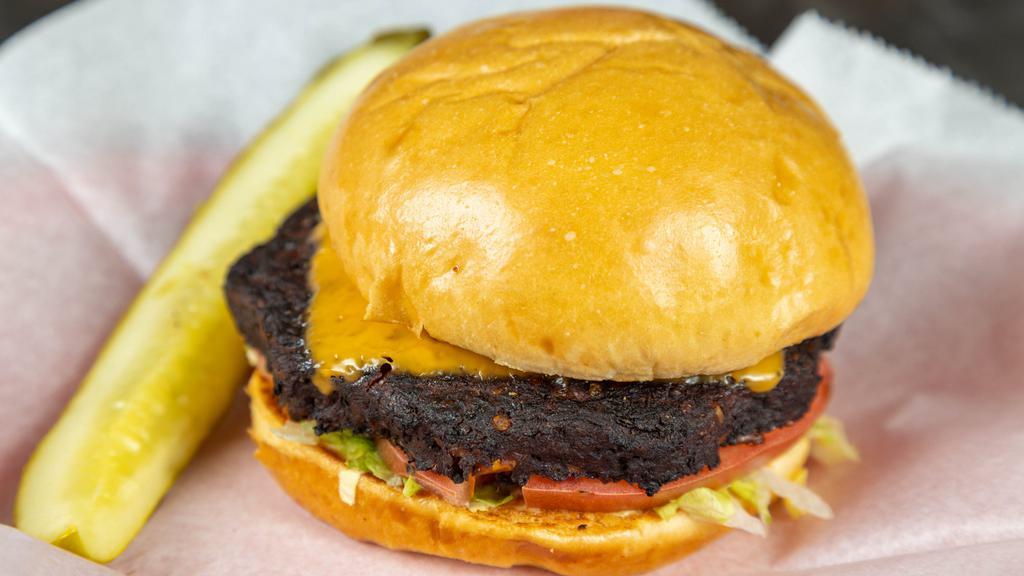 Veggie Burger · Chipotle black bean patty, lettuce, tomatoes, raw onion, mayonnaise, American cheese, and pickle.