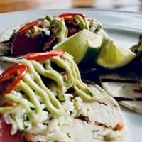 3 Yellowfin Ahi Tuna Tacos · Yellow Fin Ahi Tuna, cabbage slaw, sliced serrano chilies, avocado crema