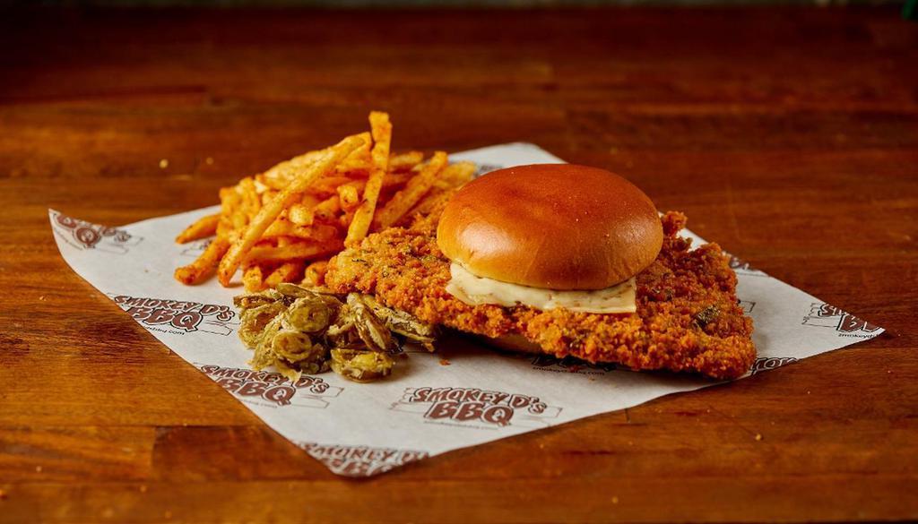 Jalapeno Tenderloin · Our classic breaded tenderloin but with a spicy twist.   Breaded with Jalapenos in the breading and served on brioche bun with Pepperjack cheese and fried Jalapenos.  Served with pickles and onions on the side.