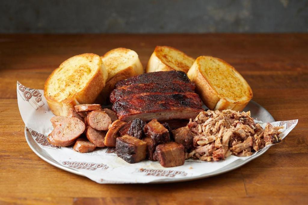 Bbq Sampler · Your choice of 3 BBQ meats served with a half rack of ribs and 4 slices of garlic bread.  Feeds 2-3 people