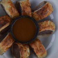 Sausage Roll · Ground Pork sausage rolled in a puff pastry, cut into sections and served with our house bee...