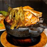 Molcajetes De Camaron · Shrimp, tilapia, jalapeños, onions, bell peppers, nopales, queso fresco, rice, beans, and a ...