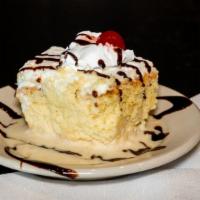 Tres Leches · Sponge cake soaked in evaporated and condensed milk, and heavy cream.