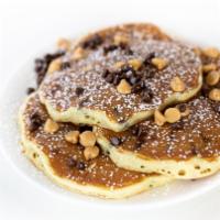 Buckeye Pancakes · Buttermilk pancakes filled and topped with Hershey’s® mini chocolate chips and Reese’s® pean...