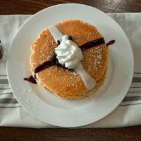 Blueberry Bliss Cakes (3) · Our fluffy blueberry-infused hotcakes are layered with a creamy cheese filling then topped w...