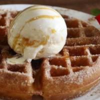 Churro Waffle · Original waffle tossed in cinnamon sugar and a scoop of vanilla ice cream. Dusted with powde...