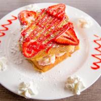 Stuffed French Toast · Strawberry cream cheese filling top with strawberries and whip cream. Dusted with powdered s...