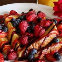 Very Berry French Toast · With strawberries, blueberries, raspberries, top with blueberry and strawberry glazed. Duste...