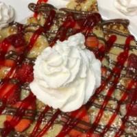 Red Velvet French Toast · Topped with strawberries. Dusted with powdered sugar and topped with whipped cream.