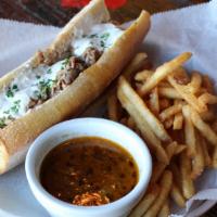 French Dip · Thin sliced roast beef topped with sautéed mushrooms and melted Swiss cheese, served on Fren...