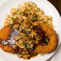 Schnitzel · Pork or Chicken Schnitzel topped with triple mushroom gravy & choice of two sides.