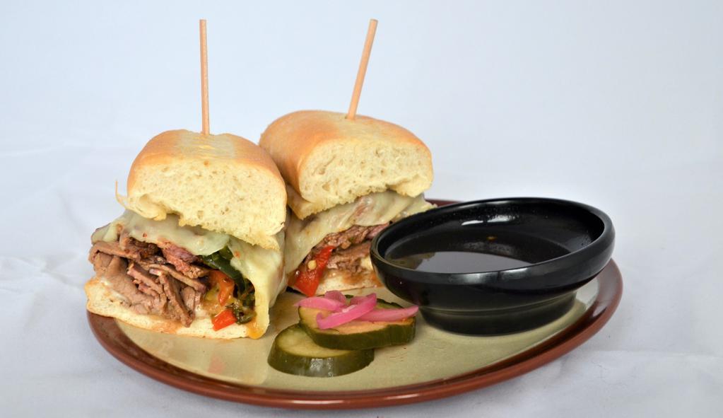 Brisket Cheesesteak. · Chopped brisket, gouda schmear, melted provolone, caramelized onions, peppers, hoagie, XO dipping jus.