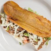 Traditional Patacon · Green fried plantain with your choice of shredded beef, shredded chicken or oven-roasted por...