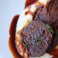 Asado Negro Dish · Slow-cooked eye round beef served with caramelized roasted sauce over a potato puree.