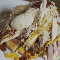 Arepa Cabimera - Beef · Arepa served with beef, ham, American cheese, shredded white cheese, boiled eggs, cabbage, k...