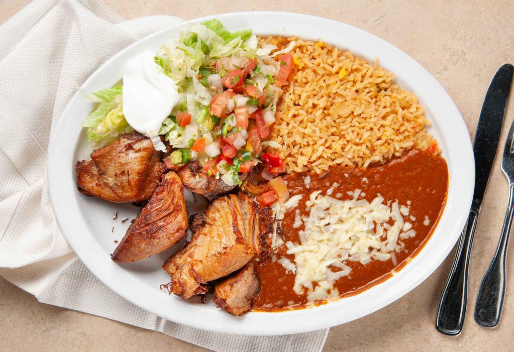 Carnitas · Perfectly seasoned slow roasted pork tips served with Mexican rice, refried beans, lettuce, pico de gallo and flour tortillas.