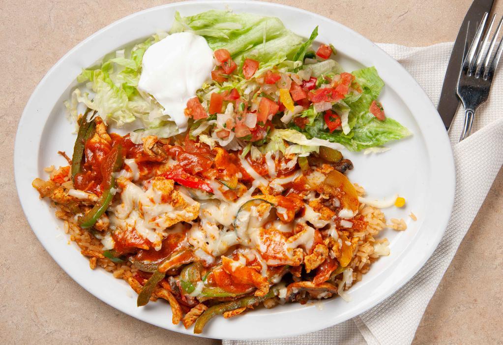 Yucatan Special · Grilled chicken or jumbo shrimp and grilled vegetables sautéed with Yucatan sauce on a bed of Mexican rice with cheese on top, served with lettuce, sour cream, pico de gallo and flour tortillas.