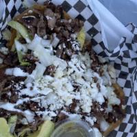 Carne Asada · Seasoned and grilled beef. Served with refried beans, fresh onions, queso fresco, and crema,...