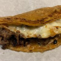 Birria Corn Quesadilla · Beef birria and melted cheese in a grilled corn tortilla, lime & salsa on the side