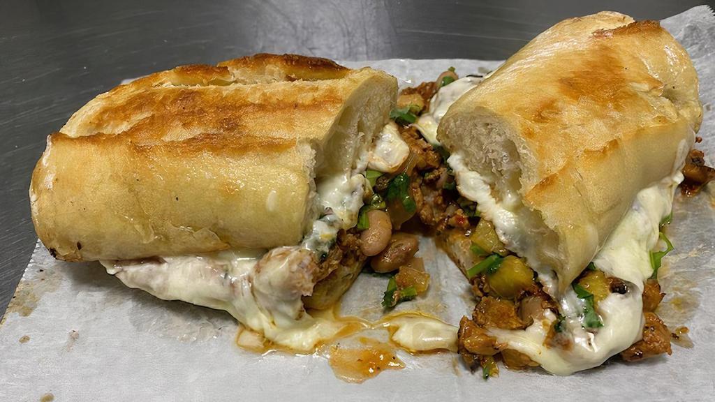 Full Torta · sliced baguette bread with mayo, beans, meat of your choice, cheese, onion, cilantro, salsa, lime