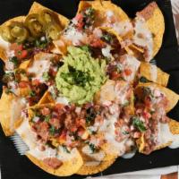 Nachos Bien Chidos · Includes refried beans, melted cheese, pico de gallo, jalapeno, sour cream. Choose Any regul...