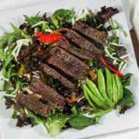 Steak Salad · Spring mix cheese, tomato, tortilla strips, avocado, black beans, grilled red and green pepp...