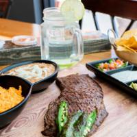 Carne Asada · Premium skirt steak with a Fried Jalapeño on the top. Includes guacamole, sour cream, and Pi...