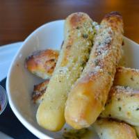 Wood Fired Bread Sticks · Roasted with generous amounts of Garlic Butter and Pecorino Romano and served House marinara...