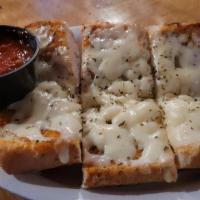 Cheesy Garlic Bread · Fresh, oven baked French bread brushed with butter and seasoned with garlic, paprika, basil ...