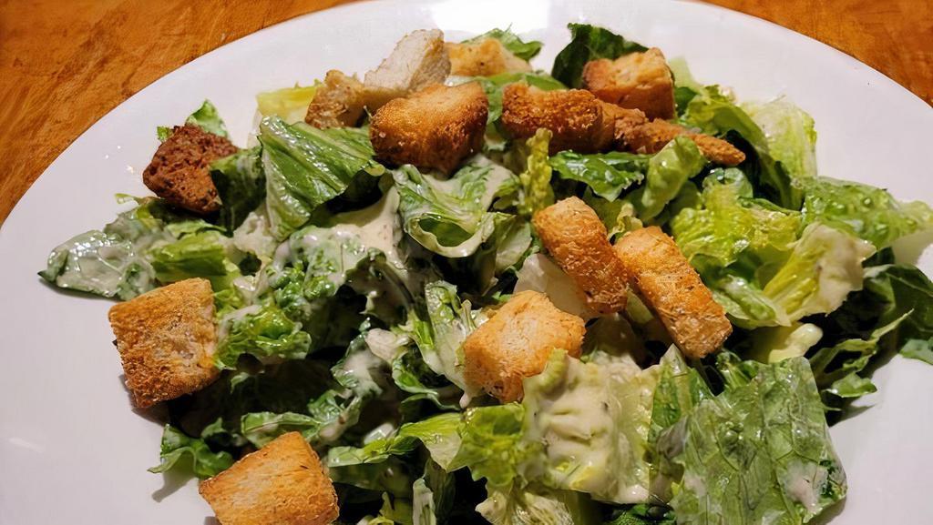 Caesar Salad · Fresh romaine lettuce topped with creamy Caesar dressing, parmesan and croutons. Dressings come on the side but can be tossed if requested.