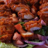 Buffalo Chicken Salad · Fresh iceberg lettuce topped with your choice of grilled or breaded chicken breast tossed in...