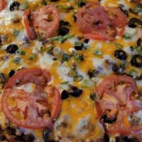 The Mexican Pizza · Taco sauce base topped with our homemade seasoned ground beef, covered with shredded mozzare...