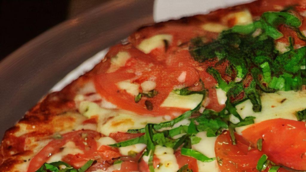 Margherita Pizza · Our original pizza sauce or olive oil base…your choice! Topped with our freshly shredded mozzarella cheese, tomatoes and fresh basil.