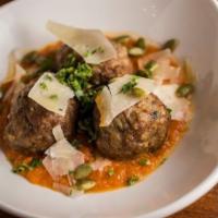 Wild Boar Meatballs · Guajillo tomato sauce, pepitas, Manchego cheese, fresh herbs.