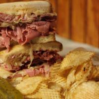 Reuben Sandwich · Grilled corned beef, swiss, kraut, on rye bread, and a side of thousand Island dressing.