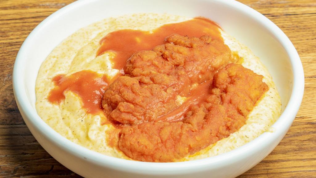 Hot Chicken & Cheesy Grits · Cheesy grits with two chicken strips, tossed in Frank's red hot sauce.