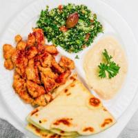 Greek Chicken Dinner · Grilled chicken, pita bread, humous, tabouli, tzatziki sauce, and drink.