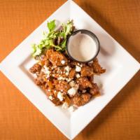 B52 Tenderloin Bites · Marinated and cajun rubbed tenderloin beef tips
served in a skillet. Topped with onion tangl...