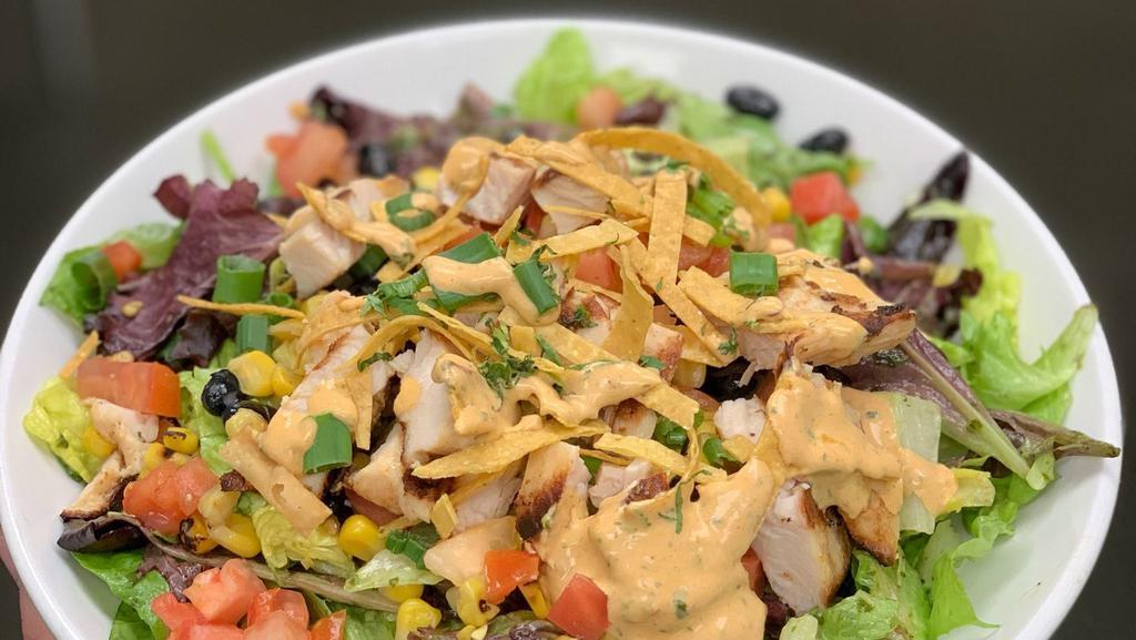Southwest Chicken Salad · Romaine lettuce, spring mix, tomatoes, green
onions, tortilla strips, diced chicken breast,
roasted corn and black beans with
a honey cilantro vinaigrette. Finished with a
drizzle of chipotle ranch.