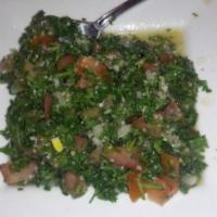 Tabbouli Salad · Chopped parsley, tomatoes, green onions, and cracked wheat in a light lemon dressing.