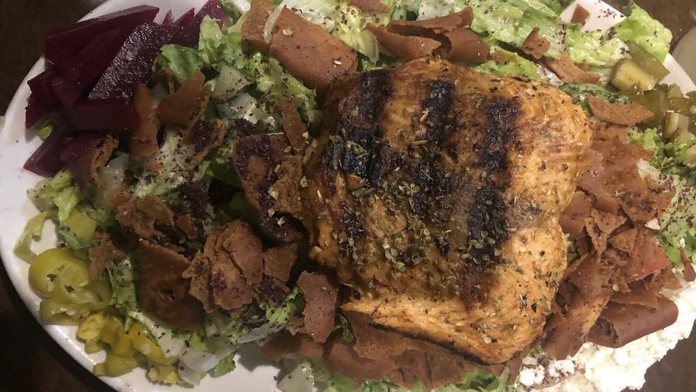 Fattoush Salmon Salad · Salad mixed with toasted pita and topped with chargrilled breast of salmon.
