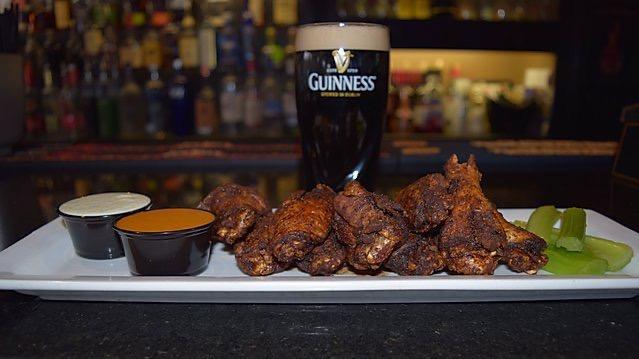 Signature Blackened Bone-In Wings · Our signature  1 lb wing plate! We use a secret double frying process to blacken our wings to perfection then lightly dust with our Top Secret dry rub. Served with chipotle BBQ & shamrock sauce for dipping.