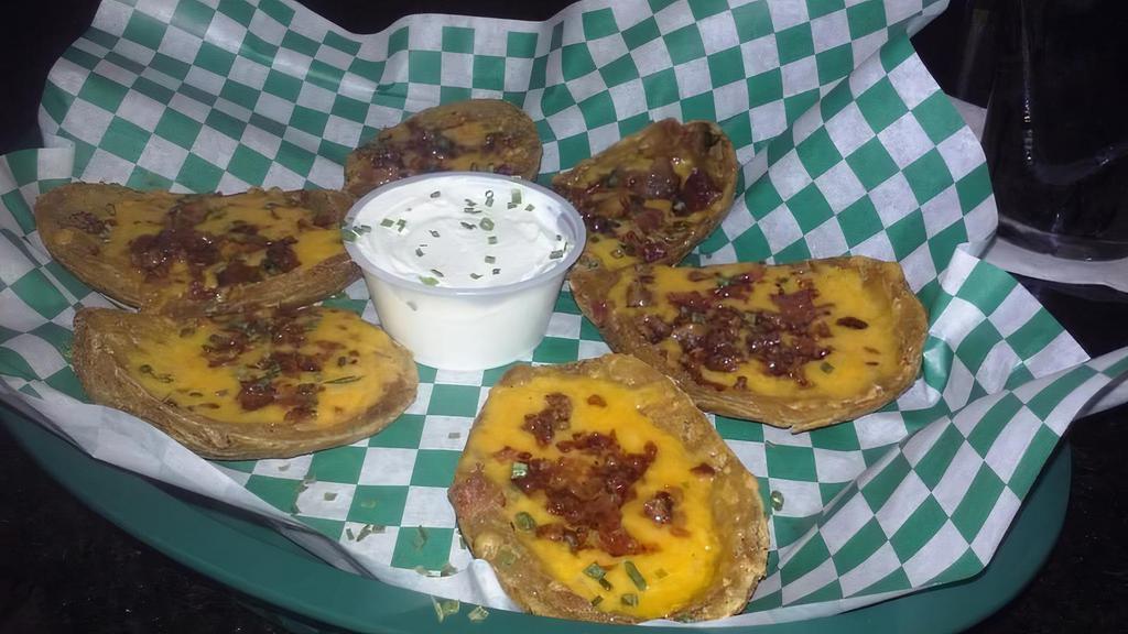 Loaded Potato Skins · Smothered with black bean and corn pico de gallo, bacon, and melted cheddar cheese. Drizzled with beer cheese and sour cream.