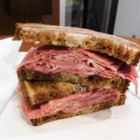 Wells St. (Corned Beef) · Hot thinly sliced homemade corned beef piled high on rye with mustard.