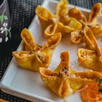 Crispy Cheese Rangoon · Hand folded wonton filled with crab and cream cheese. Served with sweet chili sauce.